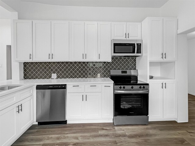 kitchen featuring white cabinets, dark hardwood / wood-style floors, decorative backsplash, and stainless steel appliances