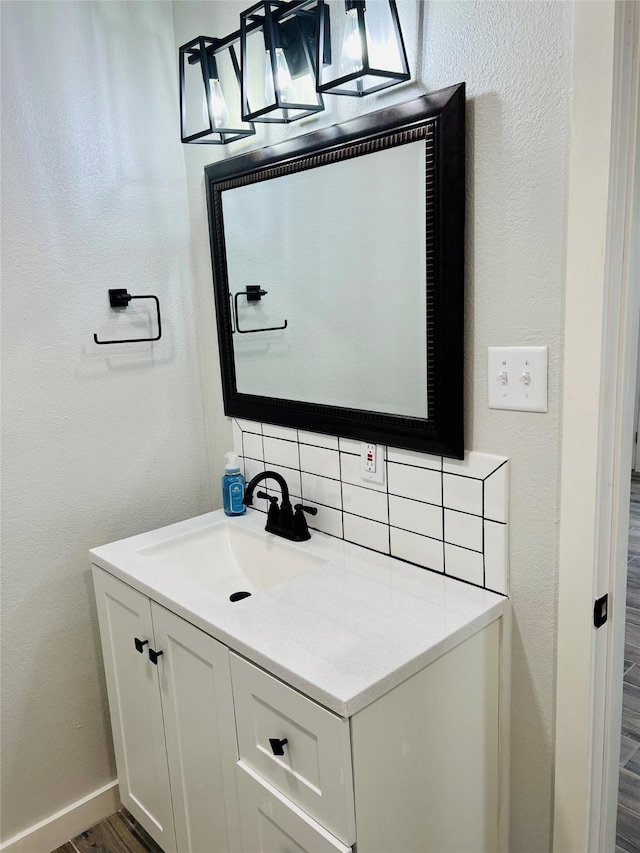 bathroom featuring vanity and decorative backsplash