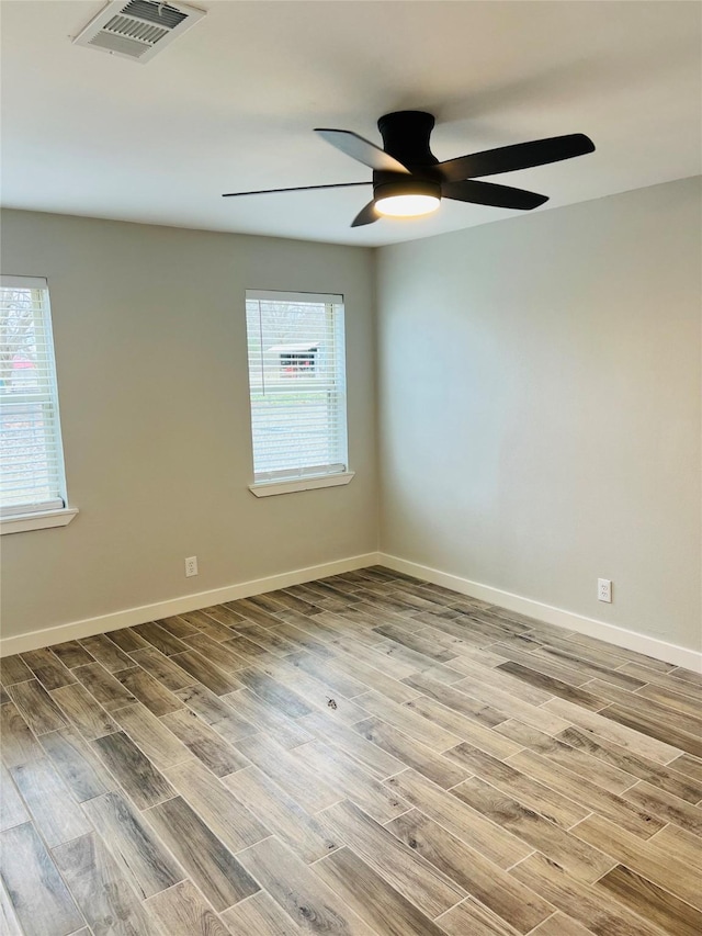 spare room with ceiling fan and hardwood / wood-style flooring