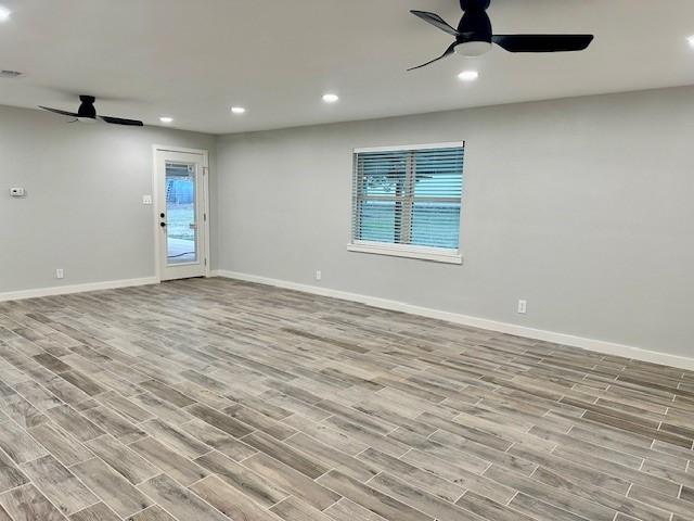 spare room with ceiling fan and light hardwood / wood-style floors