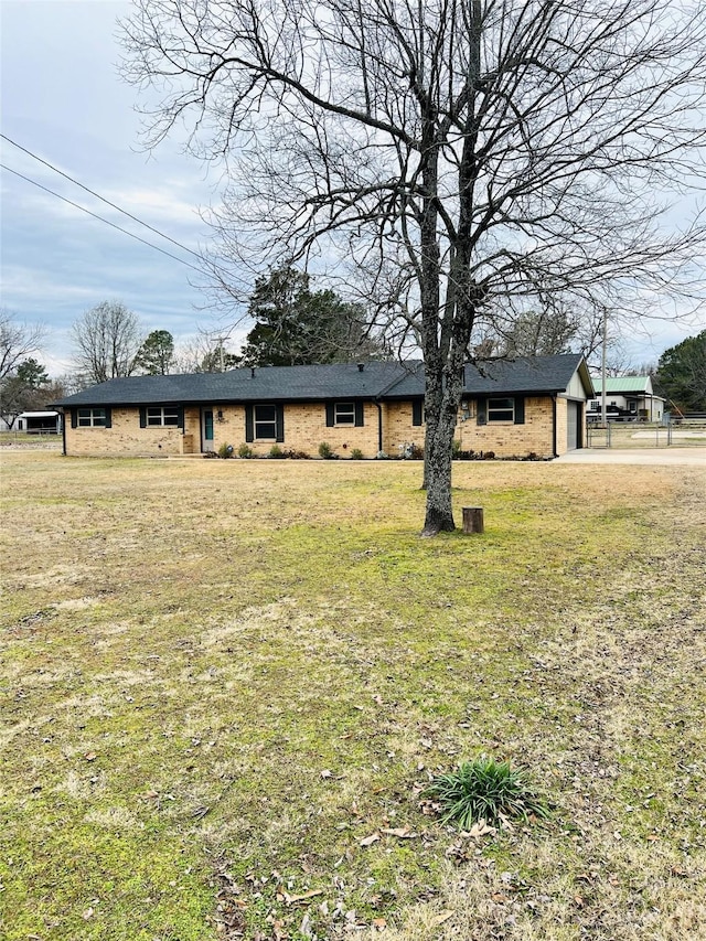 view of front of house with a garage and a front lawn