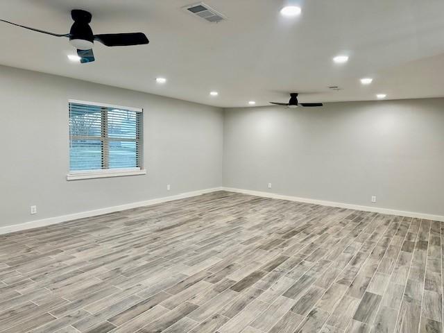 spare room featuring light wood-type flooring and ceiling fan