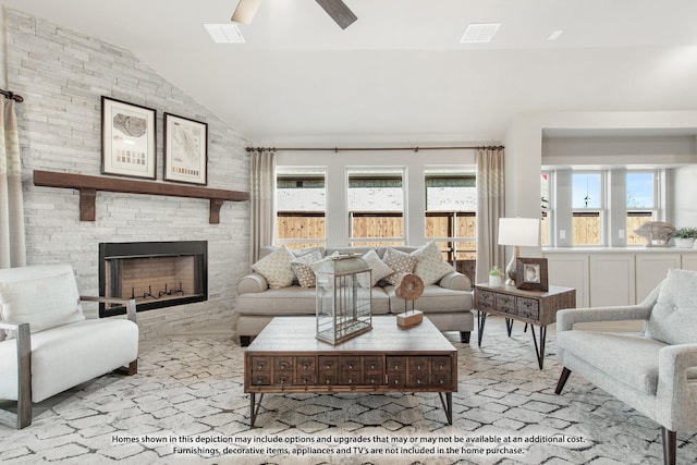 living room with ceiling fan, a fireplace, and lofted ceiling