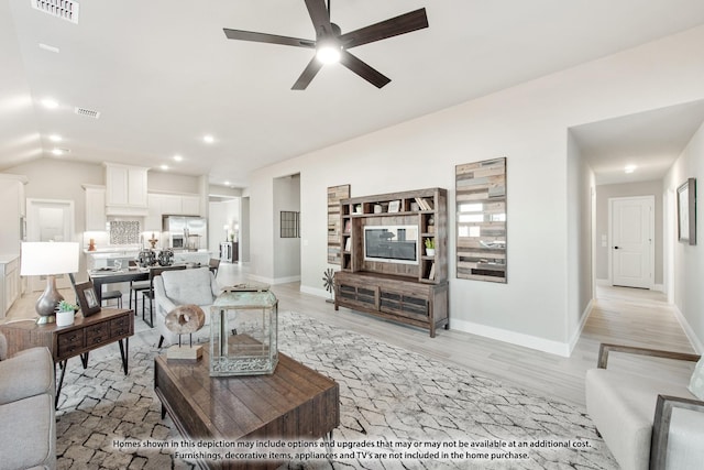 living room with ceiling fan and light hardwood / wood-style flooring