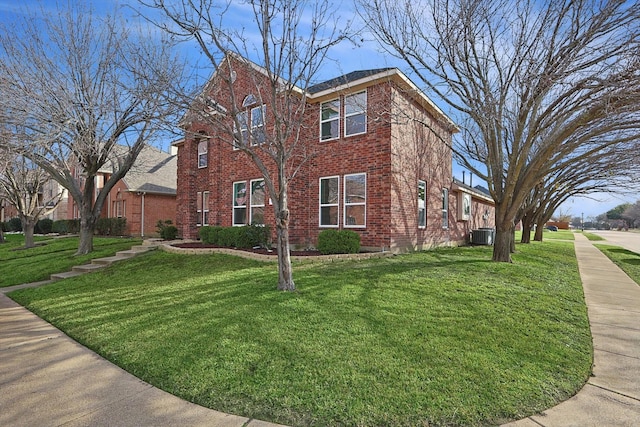 view of front of home featuring central AC unit and a front lawn