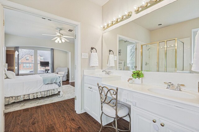 bathroom with ceiling fan, a shower with door, vanity, and hardwood / wood-style flooring