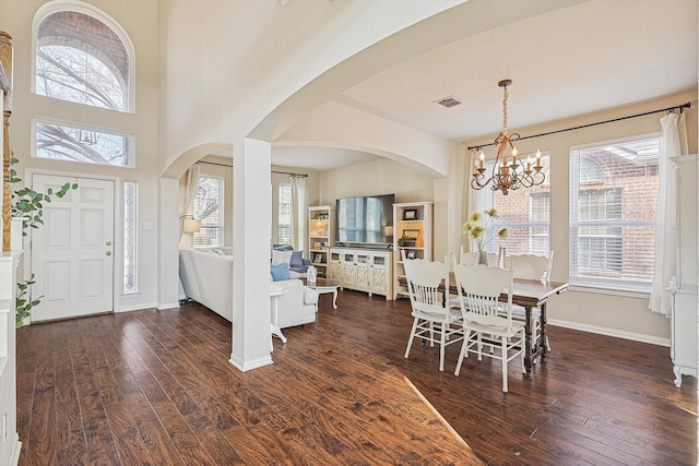 dining space featuring a notable chandelier and dark hardwood / wood-style floors