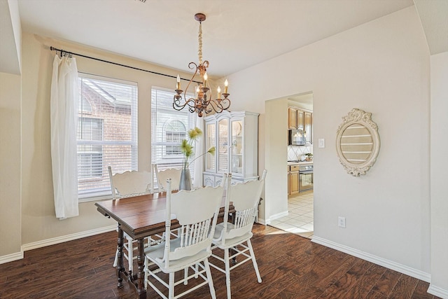 dining room featuring wood-type flooring and an inviting chandelier