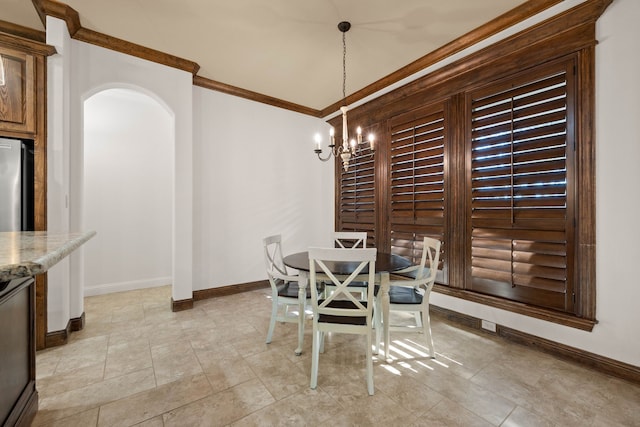 dining room with an inviting chandelier and ornamental molding