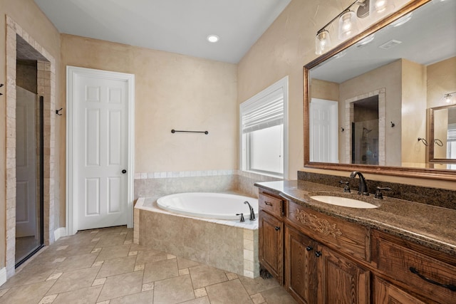 bathroom featuring vanity and shower with separate bathtub