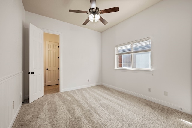 carpeted spare room with ceiling fan