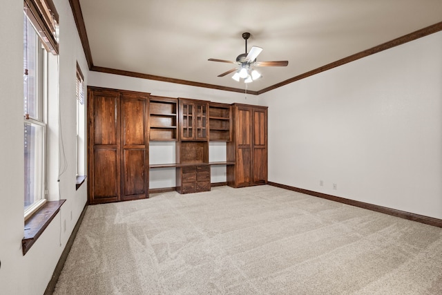 unfurnished bedroom with crown molding, ceiling fan, and light colored carpet