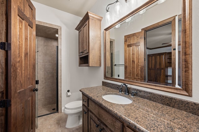 bathroom with crown molding, tile patterned flooring, vanity, a shower with shower door, and toilet