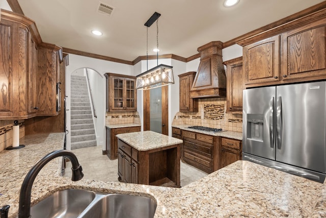 kitchen with sink, decorative backsplash, custom exhaust hood, and appliances with stainless steel finishes