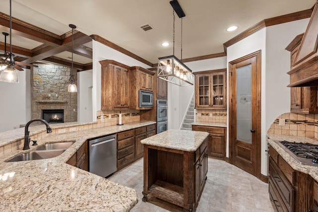 kitchen featuring hanging light fixtures, appliances with stainless steel finishes, sink, and kitchen peninsula