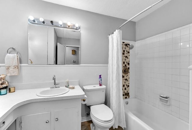 full bathroom with vanity, toilet, a textured ceiling, and shower / tub combo with curtain