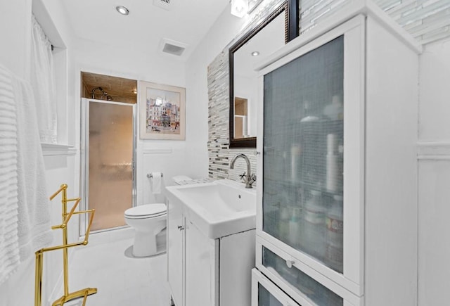 bathroom with tasteful backsplash, tile patterned floors, an enclosed shower, toilet, and vanity