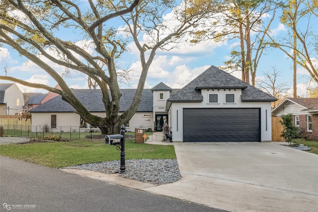 view of front of home with a garage and a front lawn