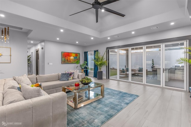 living room featuring light hardwood / wood-style flooring and ceiling fan