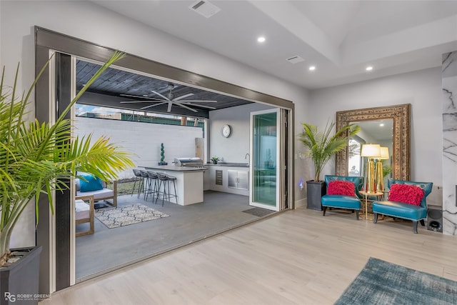 view of patio featuring ceiling fan, exterior bar, and grilling area