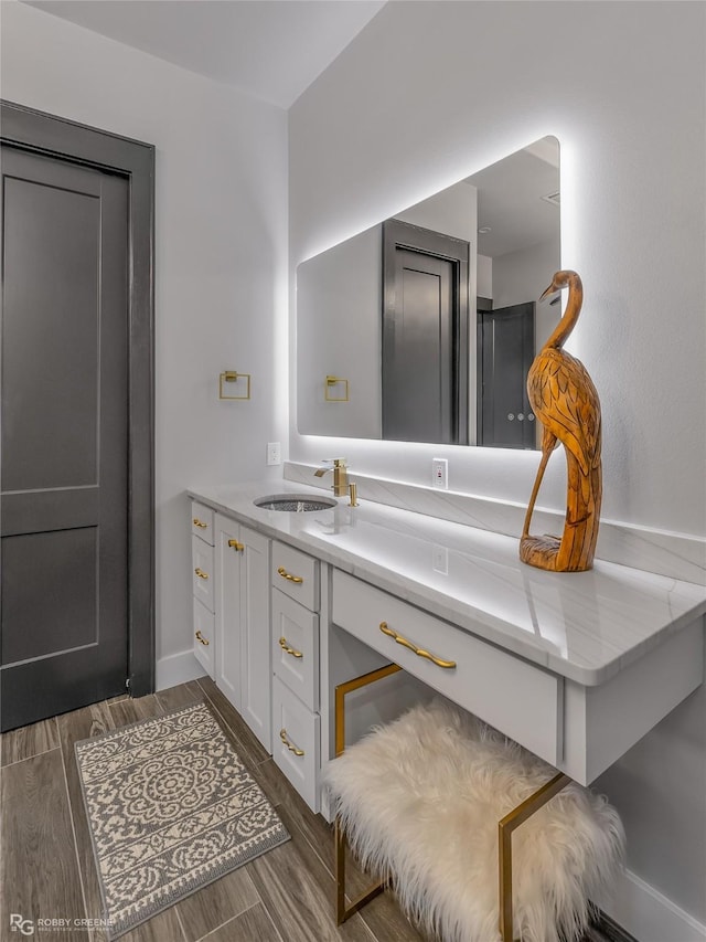 bathroom with hardwood / wood-style flooring and vanity