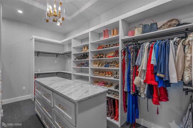 walk in closet featuring a notable chandelier