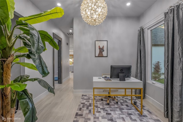 office featuring a chandelier and light wood-type flooring