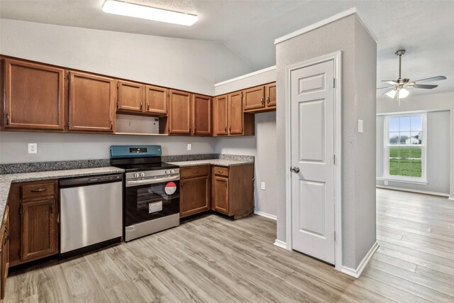 kitchen with ceiling fan, lofted ceiling, appliances with stainless steel finishes, and light hardwood / wood-style flooring