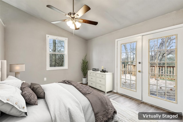 bedroom featuring multiple windows, access to outside, ceiling fan, and lofted ceiling