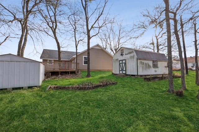 view of yard with an outbuilding and a wooden deck