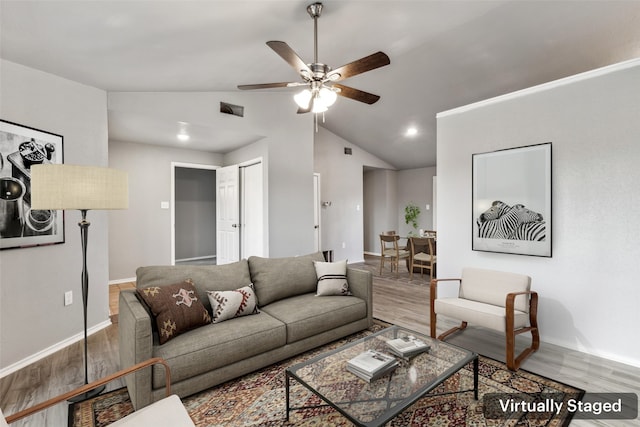 living room with ceiling fan, wood-type flooring, and vaulted ceiling