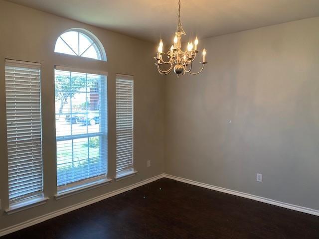 empty room with a notable chandelier