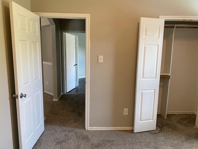 unfurnished bedroom featuring carpet flooring and a closet