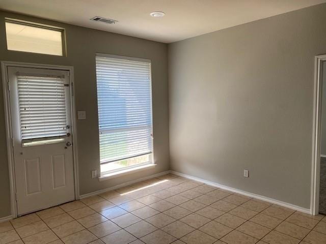 doorway featuring light tile patterned flooring