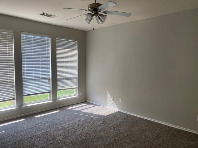 unfurnished room with ceiling fan and carpet flooring