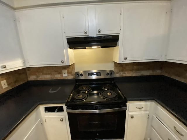 kitchen with electric range, white cabinetry, and backsplash