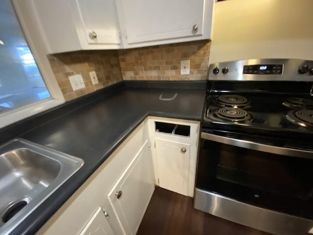 kitchen featuring white cabinetry, electric range, tasteful backsplash, and sink