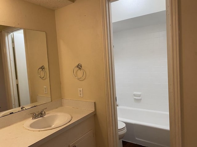 bathroom featuring vanity, toilet, and a textured ceiling