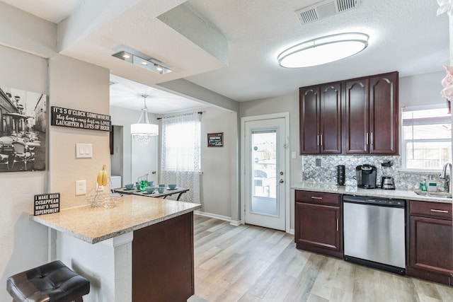 kitchen with dishwasher, sink, kitchen peninsula, pendant lighting, and a textured ceiling