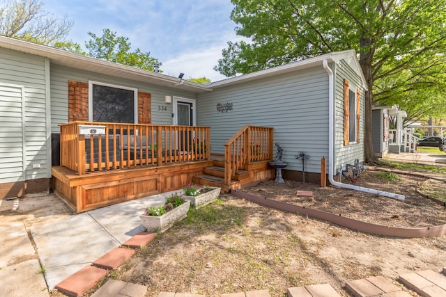 back of house featuring a wooden deck