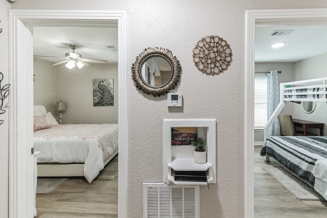 bedroom with light wood-type flooring and ceiling fan