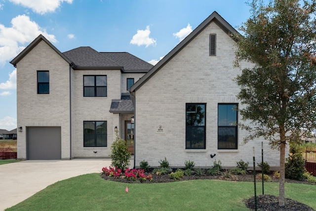 view of front of house with a garage and a front lawn