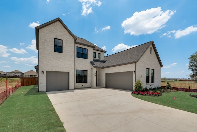 view of front facade with a garage and a front yard