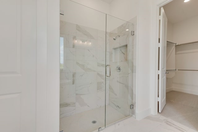 bathroom with a shower with shower door