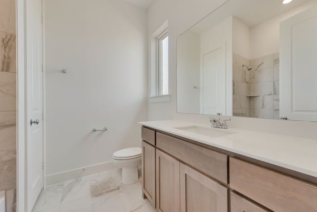 bathroom with a shower, vanity, and toilet