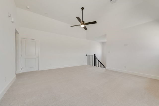 empty room with light colored carpet, ceiling fan, and lofted ceiling