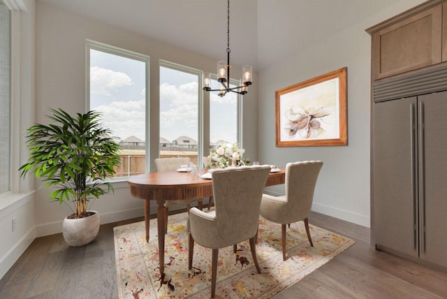 dining space featuring a notable chandelier and light wood-type flooring