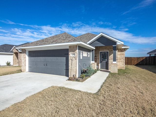 single story home with a front yard and a garage