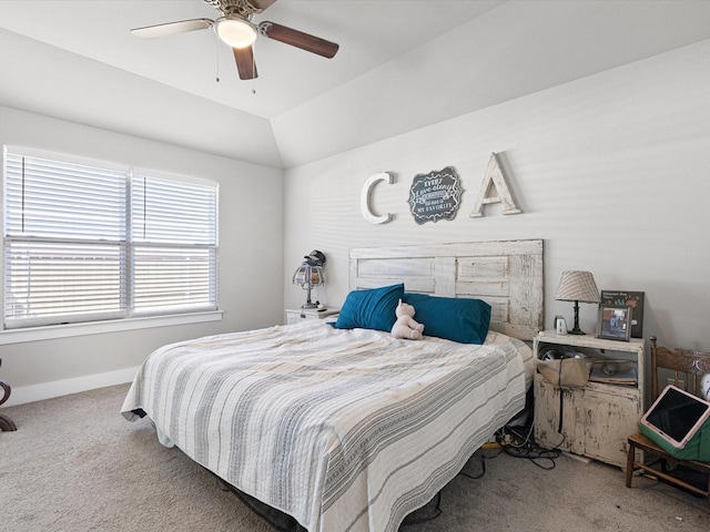 carpeted bedroom featuring ceiling fan and vaulted ceiling