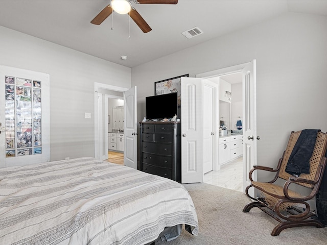 bedroom featuring lofted ceiling, ceiling fan, and connected bathroom